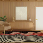Stylish area rug featured in a contemporary living room setting. The wool rug showcases an abstract design with waves of black, gray, and red, complementing the wooden furniture and neutral decor. An ideal choice for bedroom area rugs or as a focal point in the living room.