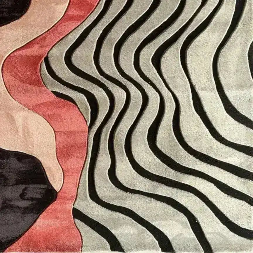 This sculptural hand-tufted area rug showcases a modern design with flowing black and white waves intermingling with soft pink and beige hues. Perfect for contemporary bedrooms and living rooms, this wool rug brings an artistic flair to any space, making it an ideal choice for those seeking unique bedroom area rugs.