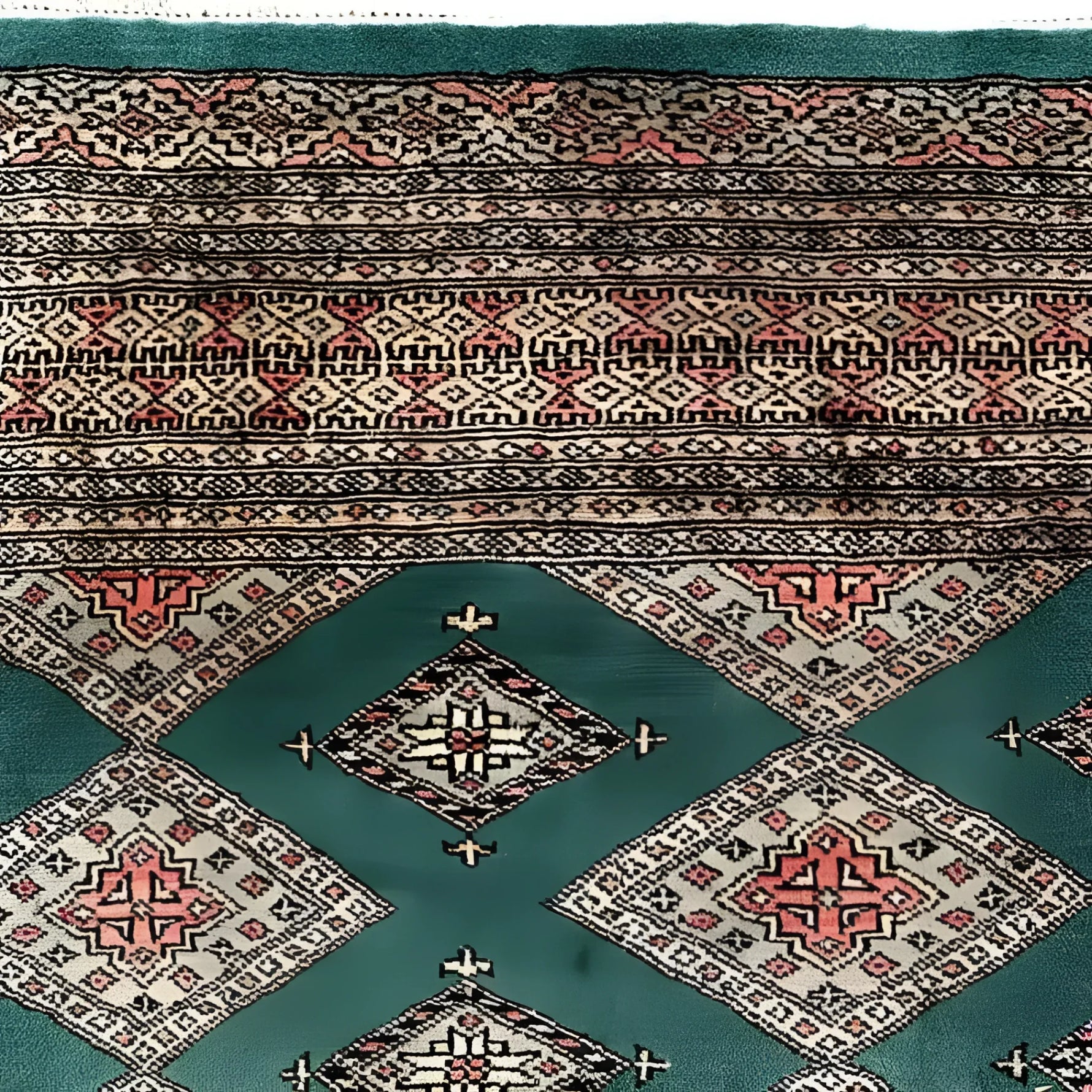 A beautifully detailed Sea Green Sarong Hand Knotted Area Rug featuring intricate geometric patterns in earthy tones. Ideal for large living room rugs, this image showcases the rug's exquisite craftsmanship and vibrant colors from a top-down view.