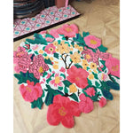 Vibrant Secret Garden Hand Tufted Round Rug showcasing a stunning floral design with bold pink, green, and yellow hues, perfect for adding a splash of color to any living room. This wool area rug is an ideal choice for those looking for unique living room rugs 8x10, combining style and comfort with its intricate round shape.