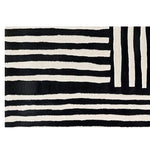 A contemporary wool runner rug featuring bold black and white stripes in an abstract pattern. Perfect for adding a modern touch to kitchens, hallways, or bathrooms, this hand-tufted rug combines style and functionality.
