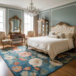 Luxurious bedroom with floral rug, elegant bed, and decorative mirror.