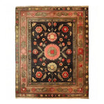 The Serene Sanctuary Hand Knotted Area Rug showcases a stunning floral design with vibrant colors on a dark backdrop. This vintage Persian-style rug is perfect for large living rooms, adding a touch of elegance and timeless charm. Ideal for those seeking rugs for living room spaces with a classic and sophisticated look.