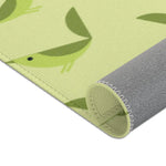 Serene songbird rug corner rolled, single green bird close-up above gray fabric backing