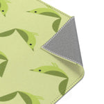 Serene songbird rug flipped corner showing green birds and gray underside with whipstitched trim