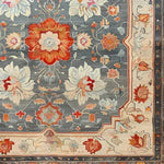 This hand-knotted area rug showcases a beautiful floral design in vibrant colors, ideal for large living rooms. The intricate vintage pattern evokes the elegance of traditional Persian rugs, making it a perfect choice for those seeking a stylish living room area rug.