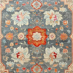 The Serenity Bloom Hand Knotted Area Rug features an elegant floral design with vintage Persian rug influences. This large living room rug showcases a harmonious blend of vibrant colors including red, orange, and blue, creating a stunning visual appeal. Perfect as a living room area rug, it adds a touch of classic elegance and sophistication.