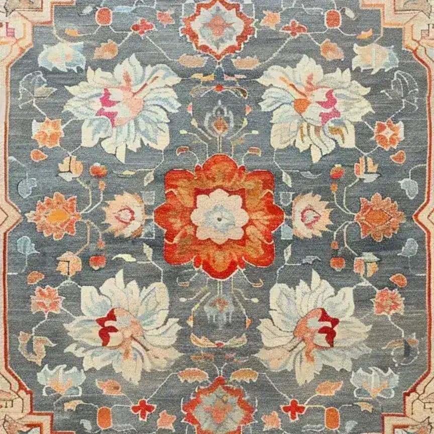 The Serenity Bloom Hand Knotted Area Rug features an elegant floral design with vintage Persian rug influences. This large living room rug showcases a harmonious blend of vibrant colors including red, orange, and blue, creating a stunning visual appeal. Perfect as a living room area rug, it adds a touch of classic elegance and sophistication.