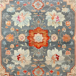 The Serenity Bloom Hand Knotted Area Rug features an elegant floral design with vintage Persian rug influences. This large living room rug showcases a harmonious blend of vibrant colors including red, orange, and blue, creating a stunning visual appeal. Perfect as a living room area rug, it adds a touch of classic elegance and sophistication.