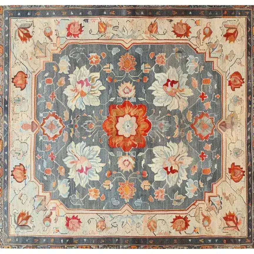 The Serenity Bloom Hand Knotted Area Rug features an elegant floral design with vibrant reds and soft blues, perfect for adding a vintage touch to large living room spaces. This Persian-inspired rug offers a timeless aesthetic, ideal for enhancing the style of your living room area.
