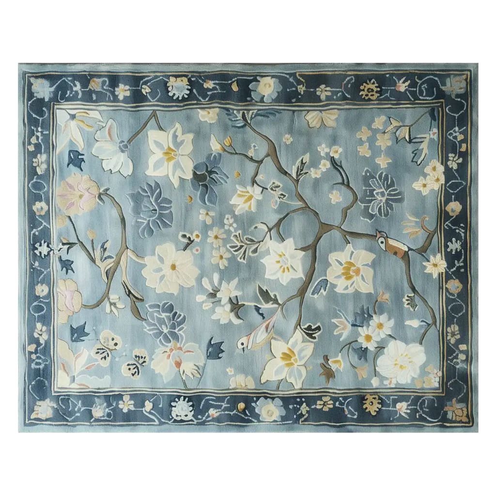 Top view of a Serenity Garden hand tufted wool area rug, featuring intricate floral patterns in soft blues and creams. Perfect for large living room spaces, this elegant wool rug adds a touch of nature-inspired design.