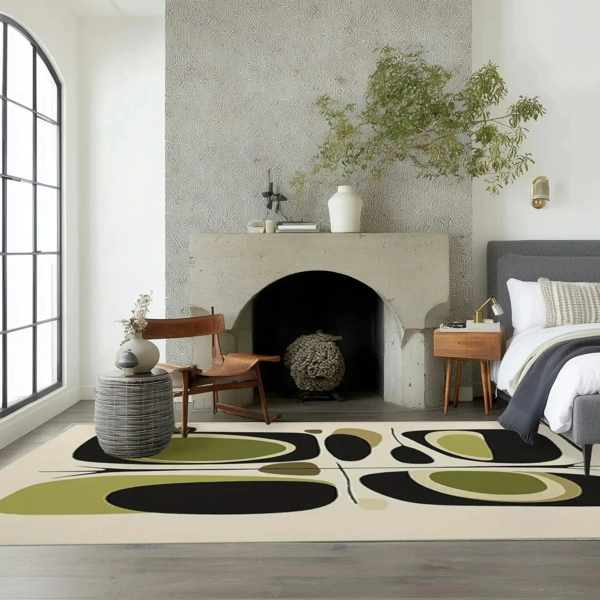 A stylish area rug with a contemporary design featuring abstract shapes in black, green, and beige, perfectly enhancing the living room and dining room ambiance. The hand-tufted wool rug adds a touch of elegance to the modern decor, complementing the minimalist furniture and the cozy fireplace setting.