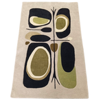 Rug with abstract design featuring black, green, and beige colors on a beige background