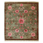 The Serenity Valley Knotted Wool Rug showcases an intricate floral design, perfect for adding elegance to any living room. This area rug features a harmonious blend of pink and green hues with detailed floral patterns, creating a stunning focal point.