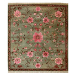 The Serenity Valley Knotted Wool Rug showcases an intricate floral design, perfect for adding elegance to any living room. This area rug features a harmonious blend of pink and green hues with detailed floral patterns, creating a stunning focal point.