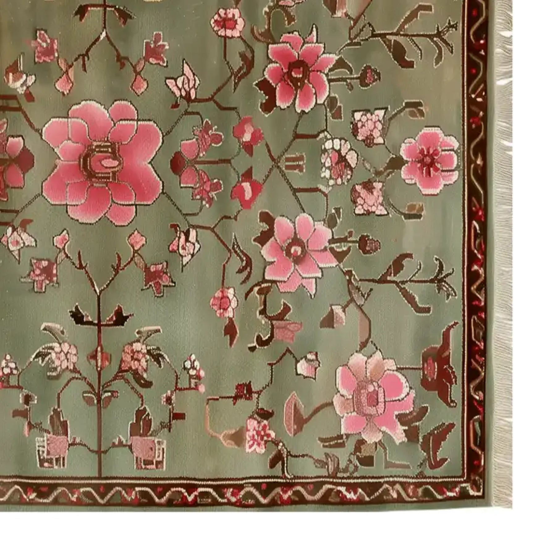 A beautifully detailed area rug featuring a floral design with pink and red flowers set against a soft green background. This stunning floral rug is perfect for adding a touch of elegance to any living room decor.