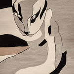 This contemporary Shadow Cat Mirage Hand Tufted Rug features an abstract design of a cat in shades of gray, black, and beige. Perfect for adding a modern touch to living room area rugs, this wool rug is a stylish choice for any space.