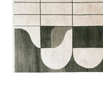 The Shadowed Abyss Grace Knotted Wool Rug features an abstract geometric pattern in shades of black and white. This contemporary area rug, made from high-quality wool, is ideal for modern living rooms, adding a touch of elegance and sophistication.