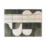 A stylish area rug named 'Shadowed Abyss Grace Knotted Wool Rug' showcasing a contemporary abstract design with bold geometric patterns in dark and light shades. This wool rug adds a modern touch, perfect for enhancing the aesthetics of living rooms.