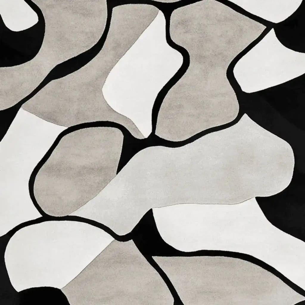 A contemporary area rug featuring an abstract design with wavy black, white, and gray shapes. This wool rug adds a modern touch to living room area rugs, ideal for stylish interiors.