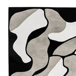 Top view of the Shadows in Motion Hand Tufted Area Rug, featuring an abstract design in shades of black, white, and gray. This contemporary wool rug is perfect for adding a modern touch to living room area rugs, offering both style and comfort.