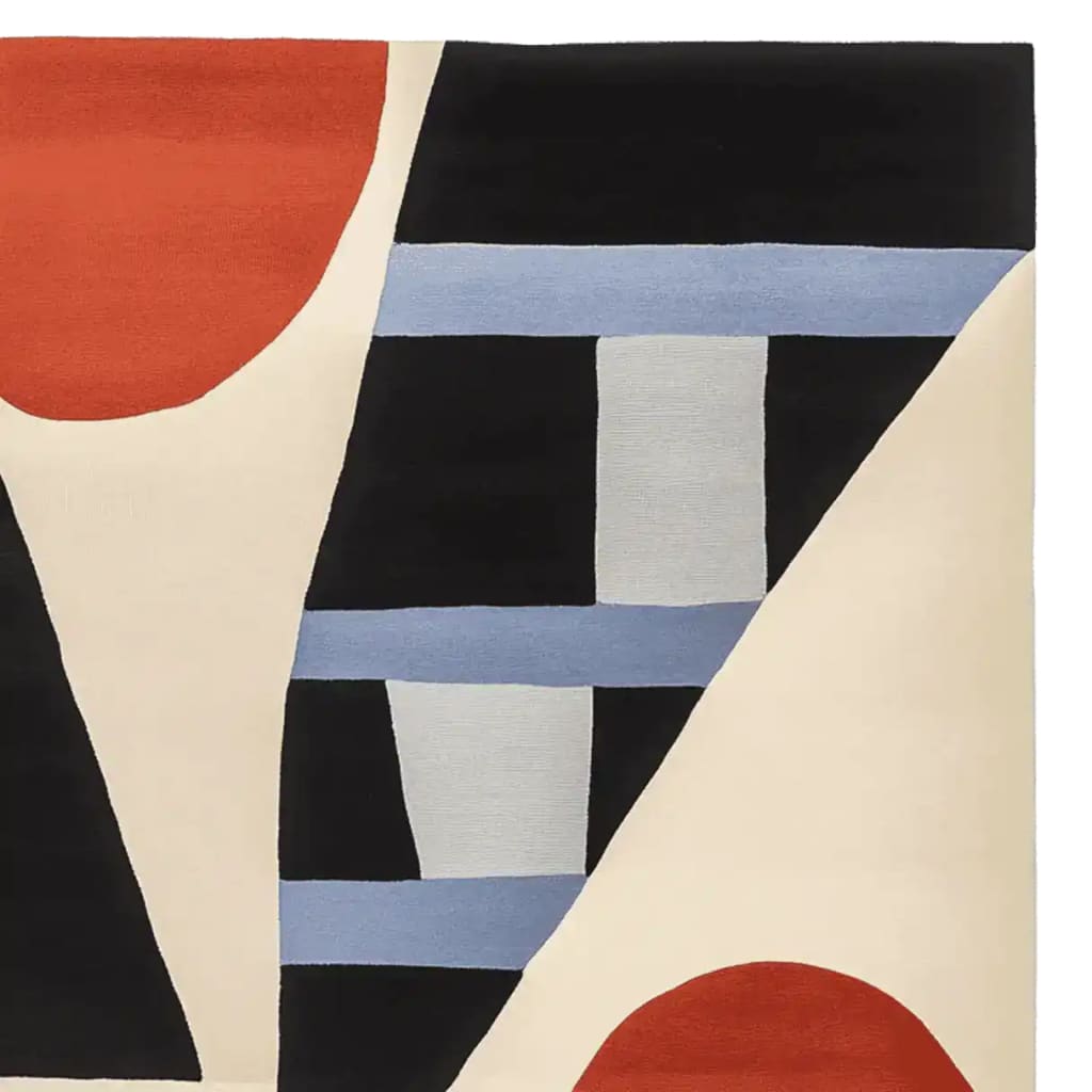 Close-up view of the Shape Rhythm Theory Hand Tufted Rug, a contemporary area rug with bold geometric patterns in black, red, blue, and cream. This wool rug is perfect for adding a modern touch to living room spaces.