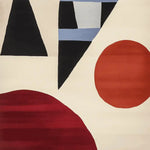 A contemporary wool area rug featuring an abstract design with geometric shapes in red, black, and blue on a cream background, perfect for adding modern flair to a living room.