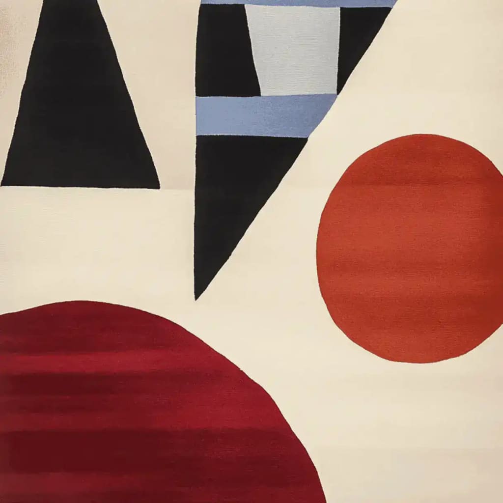 A contemporary wool area rug featuring an abstract design with geometric shapes in red, black, and blue on a cream background, perfect for adding modern flair to a living room.