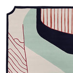 Close-up view of a contemporary wool area rug featuring an abstract design with bold lines and colors, ideal for a large living room. The 8x10 rug showcases a modern aesthetic, perfect for adding a stylish touch to any space.