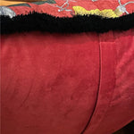 Shiny velvet scarlet throw pillow cover with a plush texture and decorative black fringe, perfect for adding a vibrant touch to home decor.