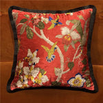 Decorative throw pillow featuring a shiny velvet scarlet background with vibrant floral and hummingbird designs, perfect for adding a touch of elegance to any living space.