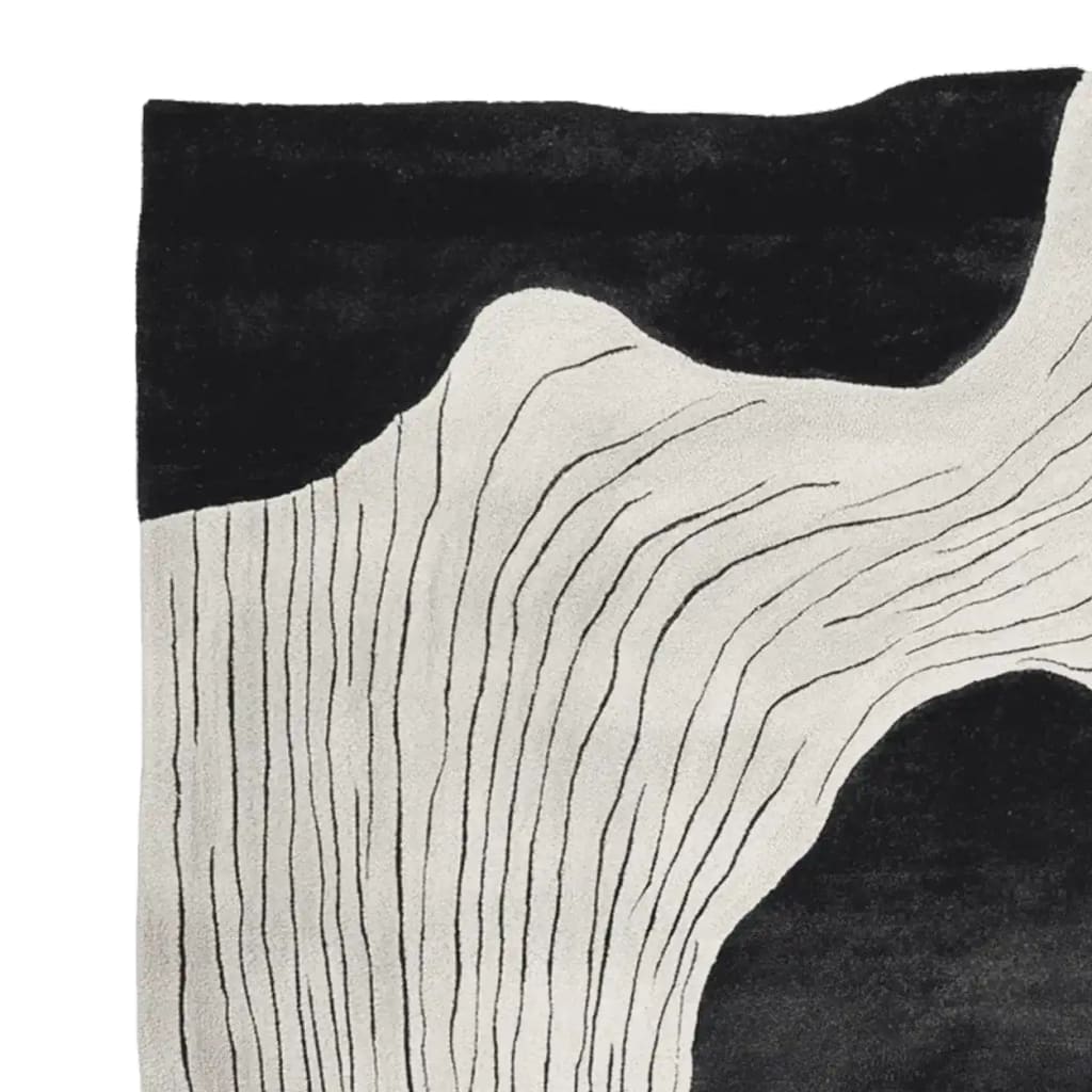 A contemporary wool area rug featuring an abstract design with flowing black and white lines. Perfect for adding a stylish touch to any living room, this 8x10 rug combines modern aesthetics with the comfort of hand-tufted wool.