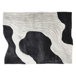 Top view of the Silent Ink Paths Hand Tufted Area Rug, showcasing a contemporary design with flowing black and white abstract patterns. This wool rug is perfect for adding a modern touch to living room spaces, available in an 8x10 size.