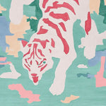 A vibrant area rug featuring an abstract tiger design in red, pink, and white against a teal background. This contemporary wool rug adds a modern touch to any living room area.