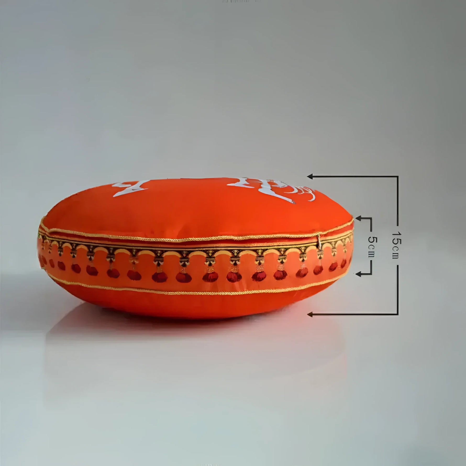 Round decorative throw pillow featuring bright orange fabric with intricate golden embroidery and red tassels, perfect for adding a pop of color to any home decor.