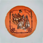 Round decorative throw pillow featuring a vibrant orange design with horses and harnesses, perfect for equestrian-themed decor.