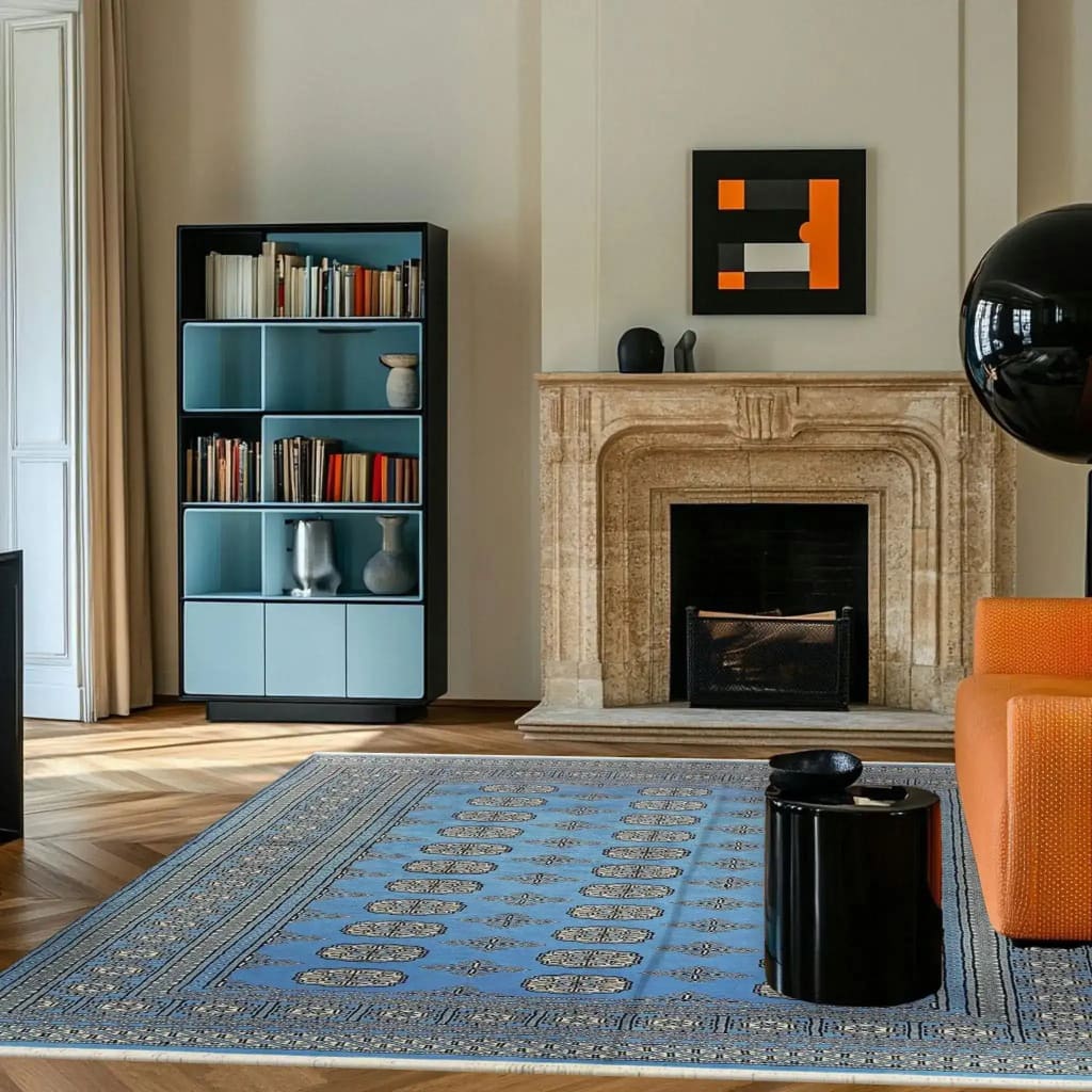 A stylish living room featuring a Sky Blue Anirudha Hand Knotted Area Rug. This elegant rug complements the room's contemporary decor, with its intricate patterns adding a touch of sophistication. Ideal for living room area rugs, it pairs beautifully with the modern fireplace and chic furnishings.