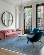 A stylish living room featuring a Sky Blue Anirudha Hand Knotted Area Rug. This elegant rug complements the modern decor with its intricate patterns, enhancing the living room area. The soft blue tones of the rug add a touch of sophistication, making it a perfect choice for those seeking rugs for living room spaces.