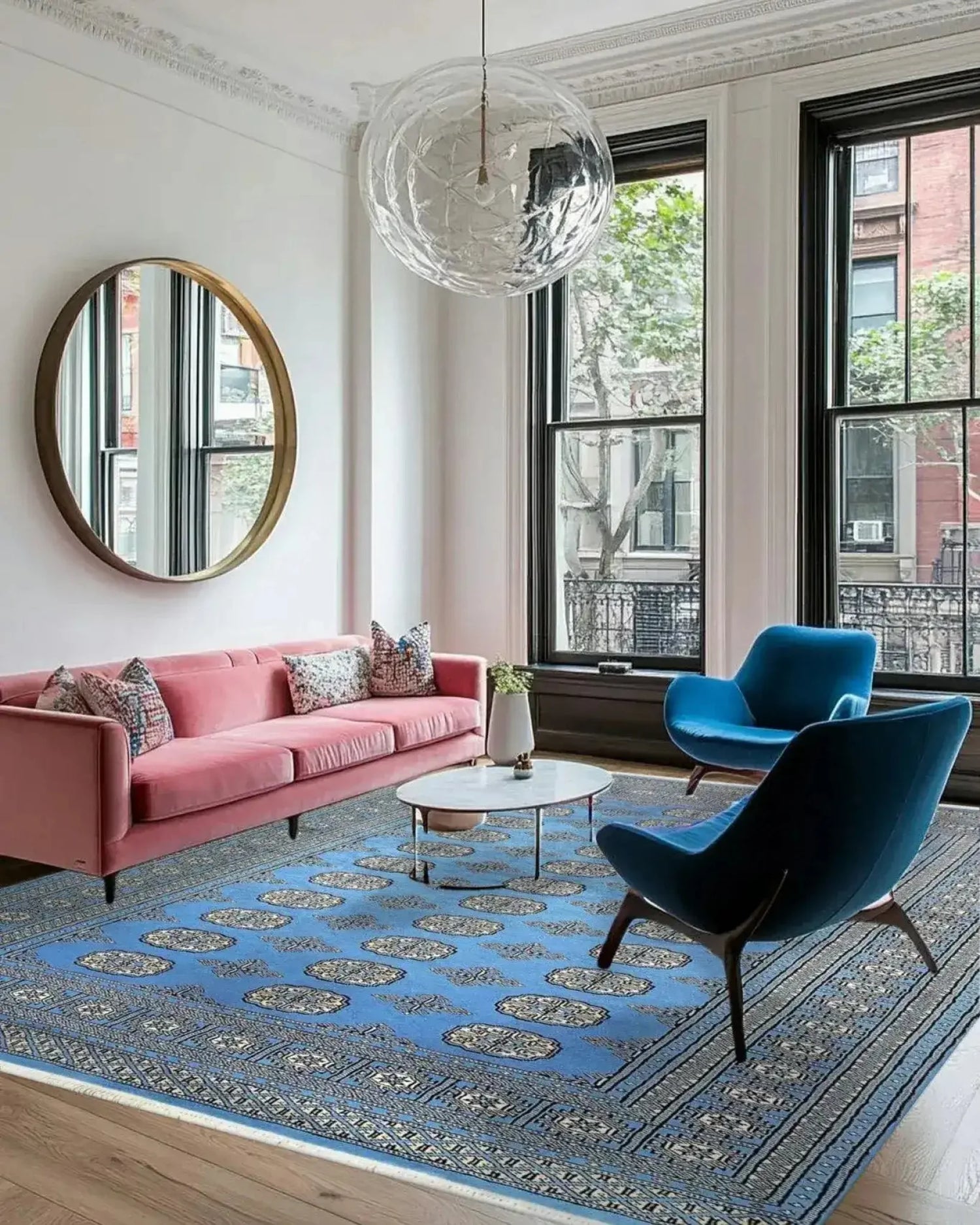 A stylish living room featuring a Sky Blue Anirudha Hand Knotted Area Rug. This elegant rug complements the modern decor with its intricate patterns, enhancing the living room area. The soft blue tones of the rug add a touch of sophistication, making it a perfect choice for those seeking rugs for living room spaces.