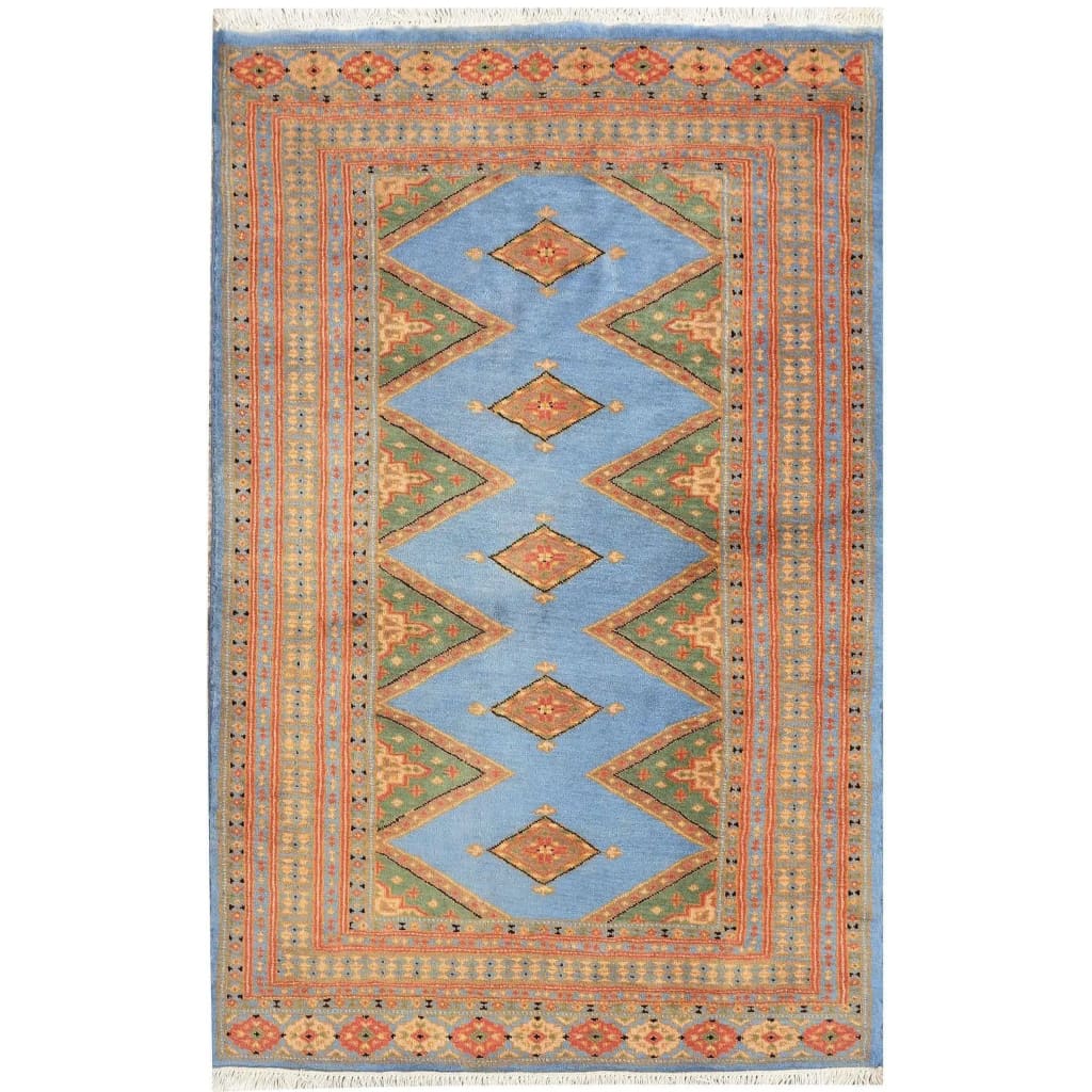 Sky Blue Java Kingdom Hand Knotted Area Rug featuring intricate geometric patterns in vibrant colors, ideal for enhancing the elegance of large living room spaces. Perfect choice for those seeking stylish rugs for living room decor.
