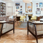 A stylish living room featuring the Sky Blue Java Kingdom Hand Knotted Area Rug, perfect for adding a touch of elegance to any space. This large living room rug showcases an intricate design with vibrant colors, complementing the modern furniture and art-filled walls.