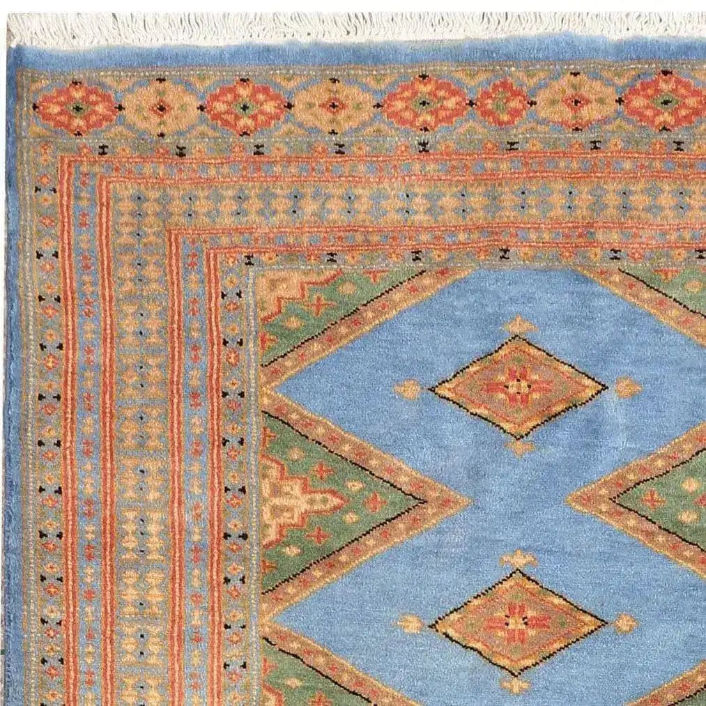 A beautifully designed Sky Blue Java Kingdom Hand Knotted Area Rug, perfect for enhancing your living room decor. The rug features intricate patterns with vibrant colors, ideal for those seeking large living room rugs that add a touch of elegance and style.