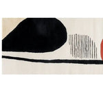 Close-up view of the Sky Song Hand Tufted Wool Rug, showcasing its contemporary design with abstract black and white shapes. Ideal as a hallway runner rug, kitchen rug, or bathroom runner rug, this wool rug adds a modern touch to any space.