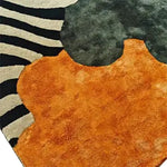 Close-up view of the Sleek Stripes Tufted Wool Rug showcasing its vibrant abstract design with bold black and white stripes alongside rich orange and grey shapes. Perfect for adding a contemporary touch to your dining room or office, this wool area rug blends modern aesthetics with comfort.