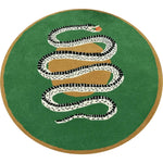 A vibrant round wool rug showcasing a striking snake and apple design on a lush green background. Perfect for a dining room, this large area rug blends bold style with functionality, ideal for formal dining room settings.