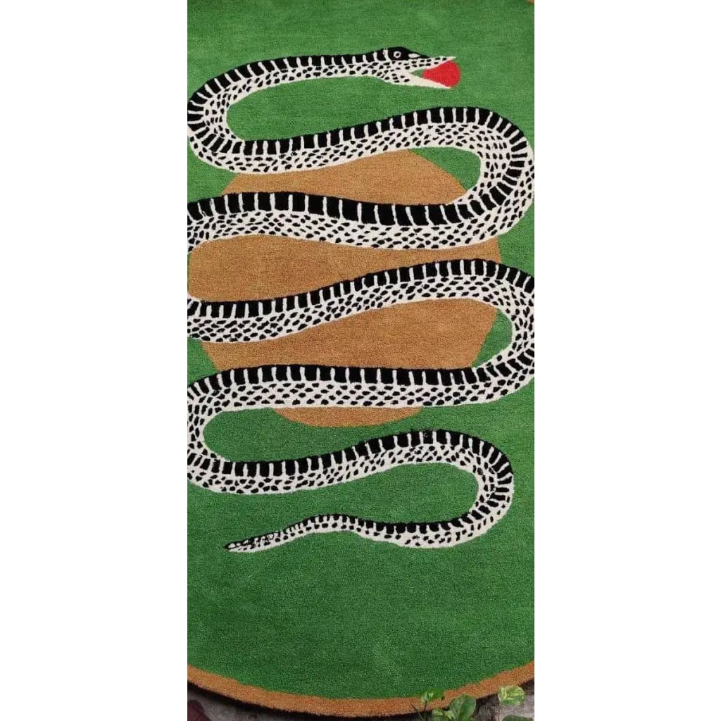 Vibrant round wool area rug featuring a striking snake and apple design in green and gold tones, perfect for enhancing dining room decor. This large area rug is ideal for formal dining rooms, adding a unique touch with its bold pattern.