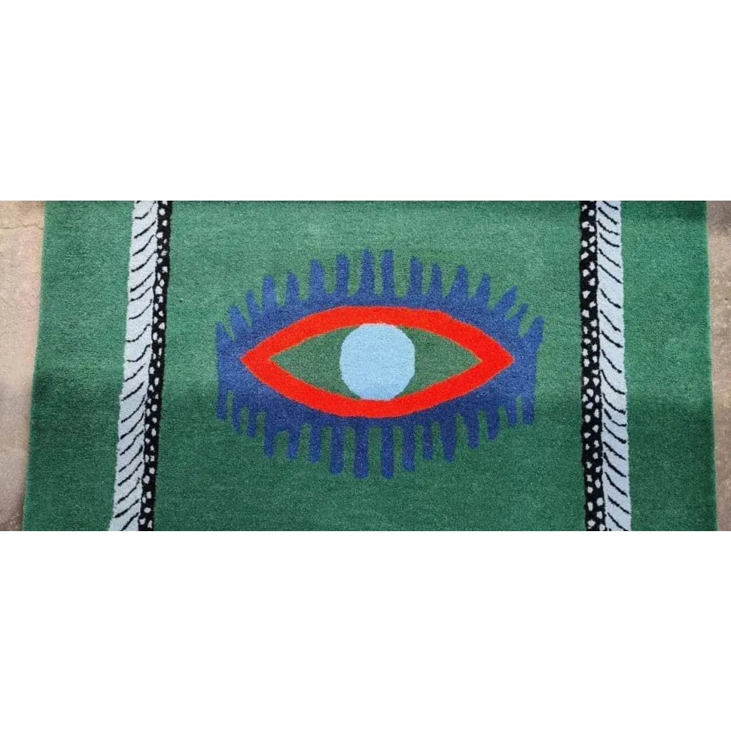 This vibrant area rug features a striking design with a central motif of red evil eyes and blue accents set against a green background. Perfect for adding a bold touch to dining room areas, kitchens, or hallways, this hand-tufted wool rug combines vintage charm with modern aesthetics. Ideal as a kitchen runner rug or a hallway runner rug, it brings a unique flair to any space.