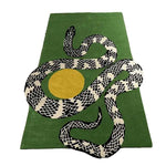 A contemporary wool area rug featuring a striking black and white snake design intertwined with a bold yellow sun on a lush moss green background. Ideal for living rooms, this large 8x10 rug adds a modern artistic touch to any space.