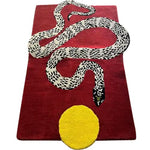Contemporary wool area rug featuring a striking snake and sun design on a deep red background, perfect for adding a bold statement to your living room. This 8x10 hand-tufted rug combines artistry and function, ideal for those seeking unique living room rugs.
