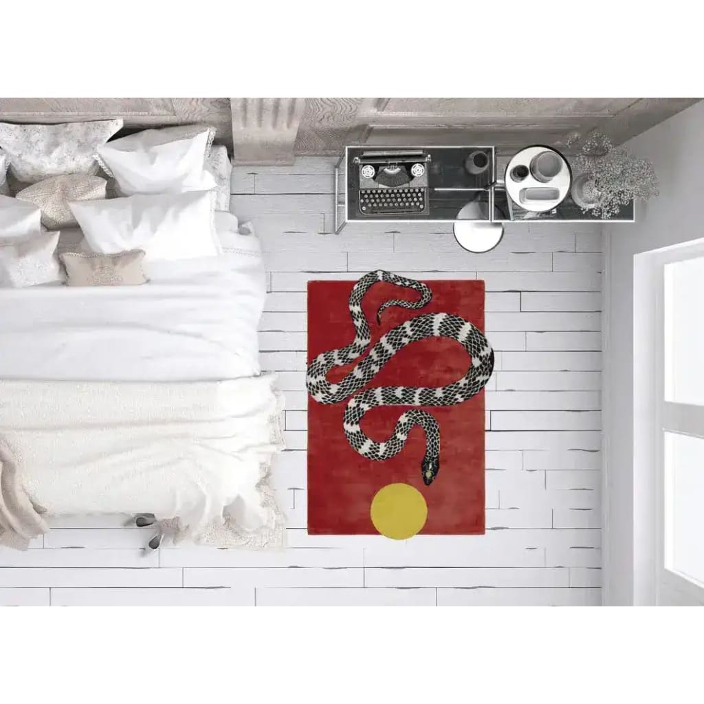 Top view of a contemporary area rug featuring a striking snake and sun motif on a bold red background, perfect for living room decor. This hand-tufted wool rug, measuring 8x10, adds a modern touch to any living space.